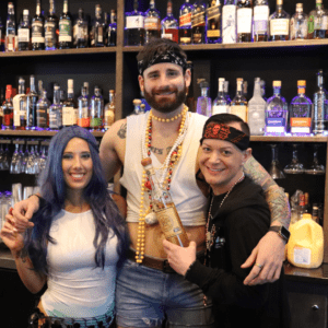 people posing with 813 tequila bottle